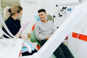 Dentist and patient speaking confidently in modern exam room