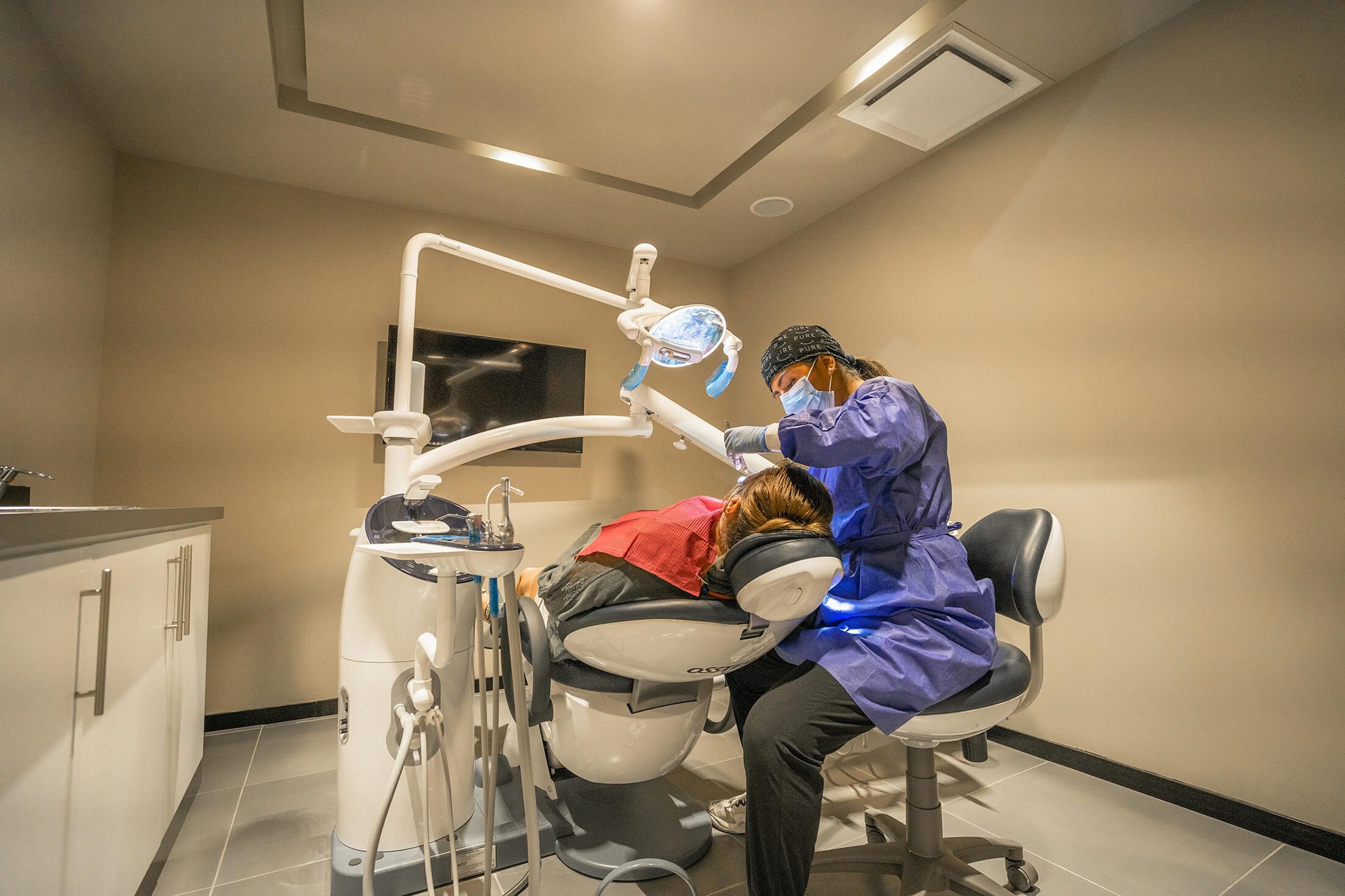 patient undergoing dental procedure in treatment room