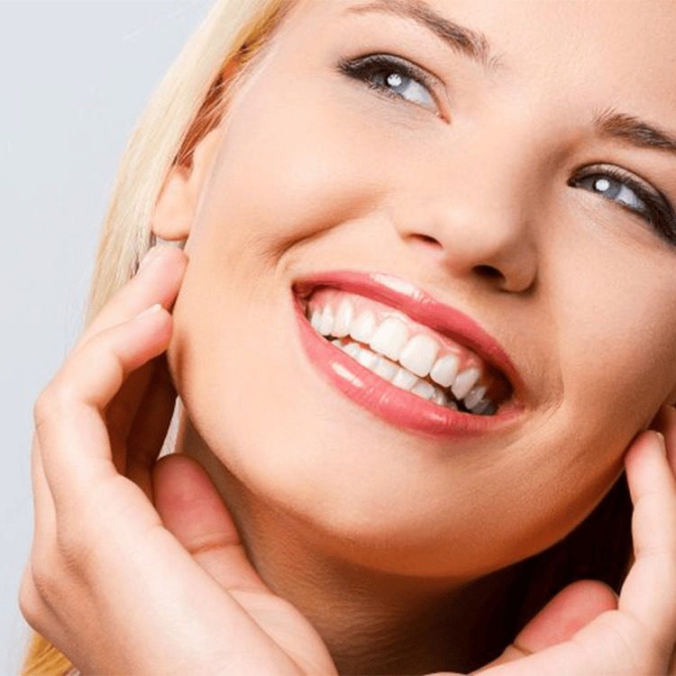 woman showing off smile with head tilted