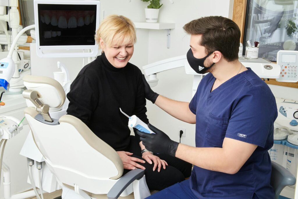 a patient and dentist smiling